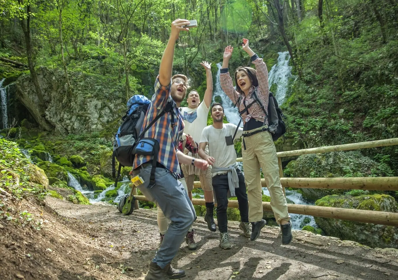 A group of friends enjoying themselves and snapping selfies out in nature.