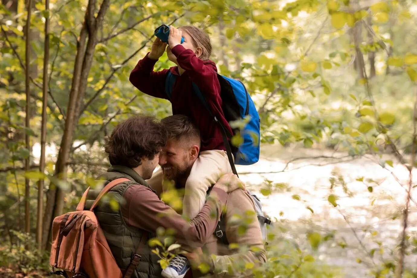 A girl and her dads enjoying a family trip.